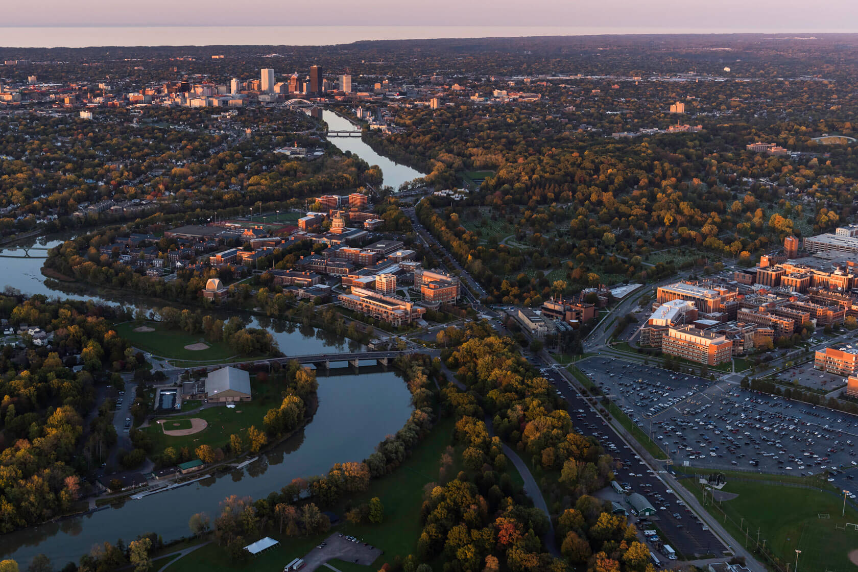 Aerial photo showing the city of Rochester, NY, the university campus, Strong Memorial Hospital, Genesee River, and part of the Genesee park.