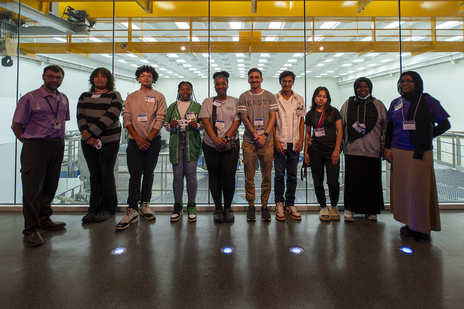 Group photo of BEST Program students with tour guide in the OMEGA EP viewing gallery.