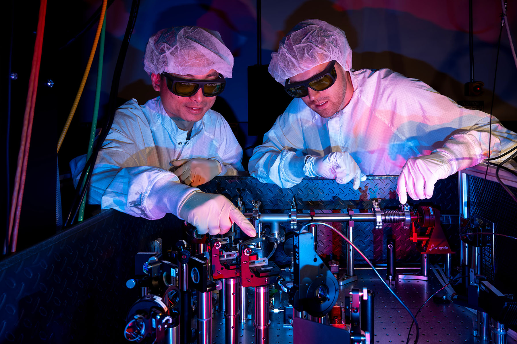 Chengyong Feng Rob Holcomb behind table in the High Power lab.