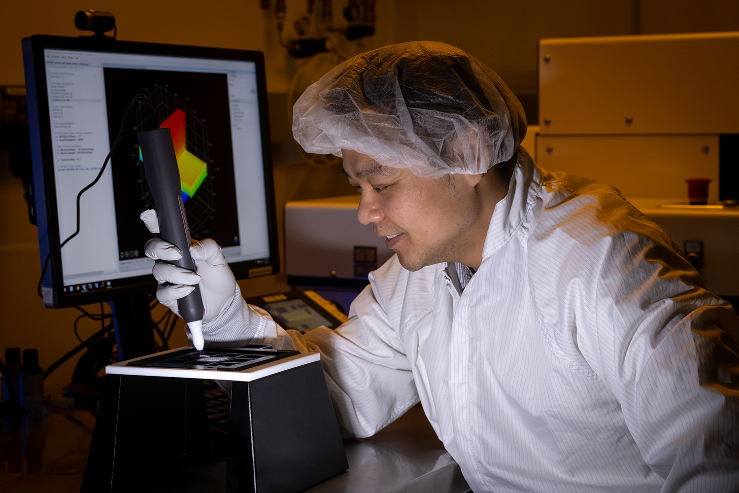 Ming Wang using plasma etching 3-D printer located in Target Fabrication's Tritium Laboratory.