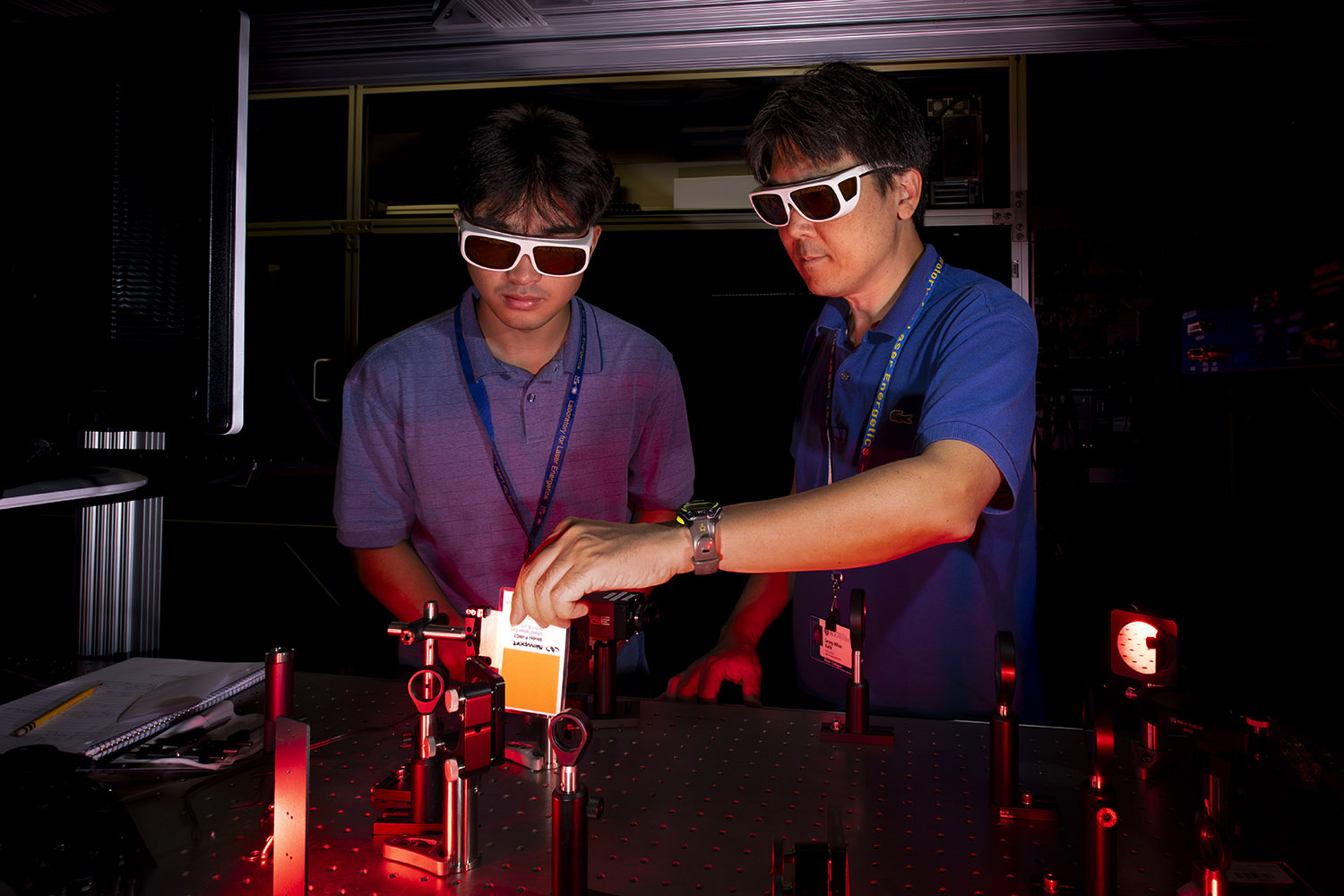 Students wearing white rimmed glasses doing an experiment.
