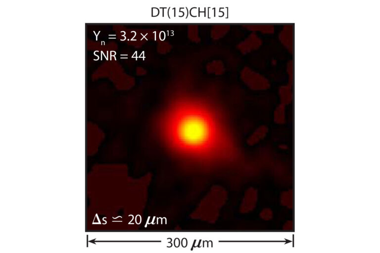 An image of a bright yellow light surrounded by orange light on a dark backgroun.
