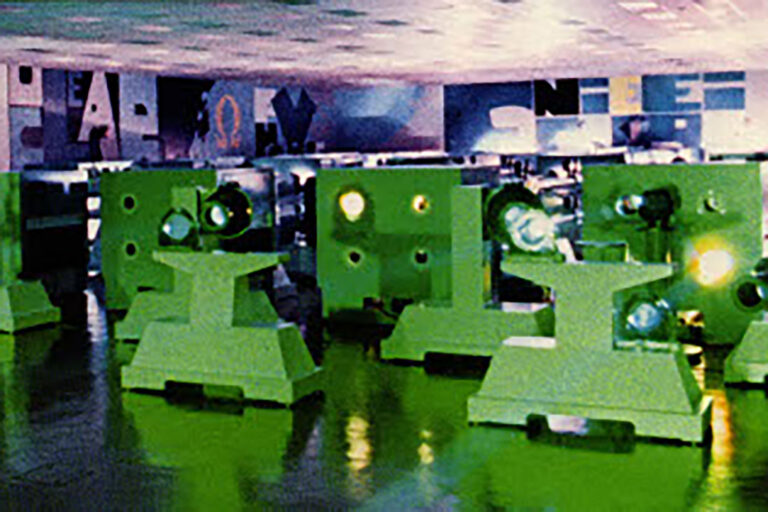 Historic photo of a laser facility with rows of large green optical or laser beamline components.