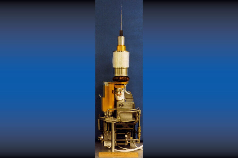 A large moving cryostat base supports a tiny target assembly..