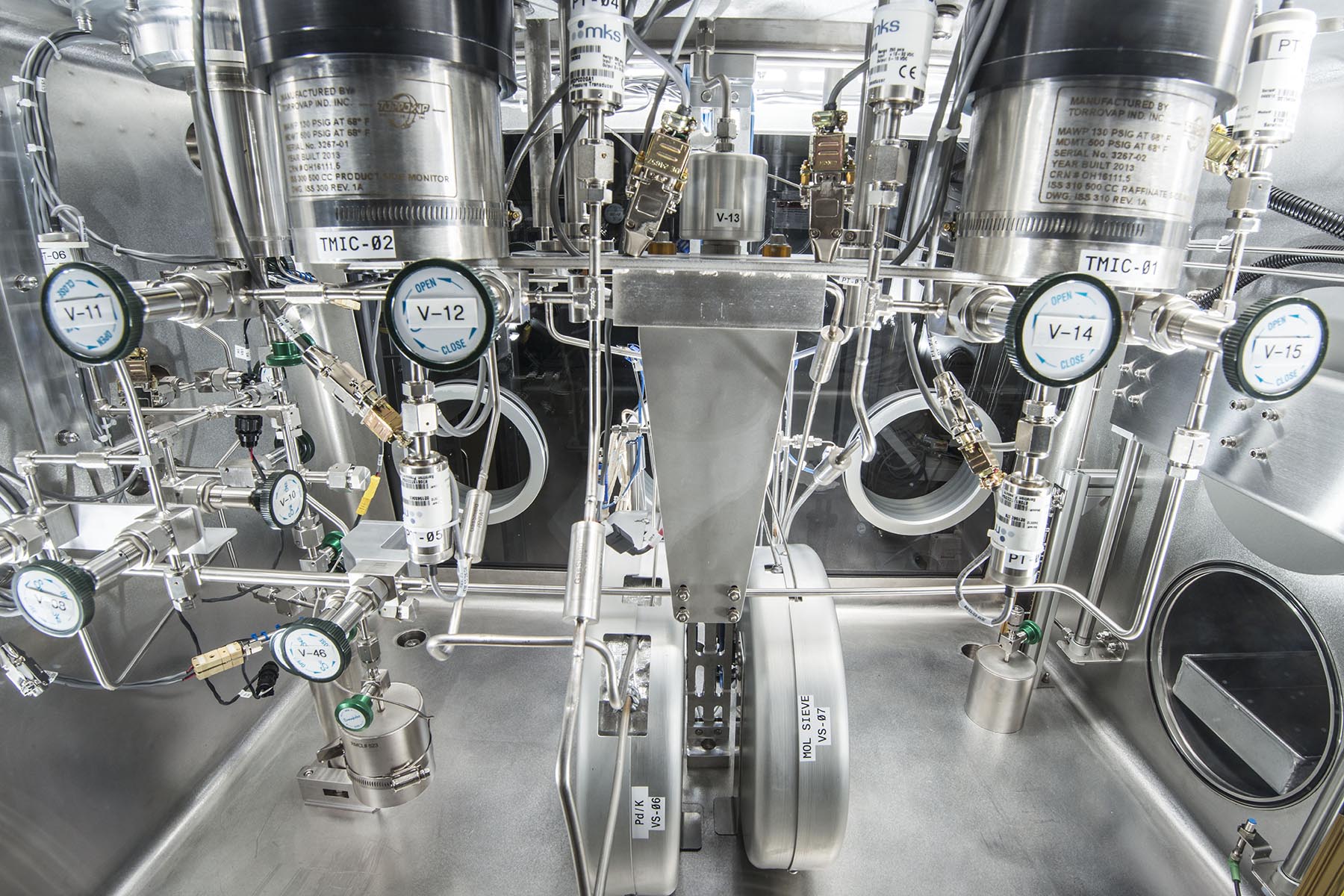 Stainless-steel laboratory setup with complex valves, gauges, and pressure systems used for precision research or cryogenic operations.