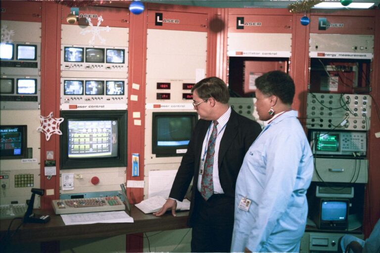 Dr. Robert McCrory and Terleta “T.” Willis reviewing computer systems.