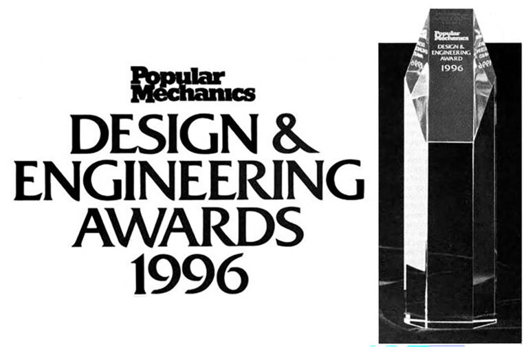 Image of the 1996 Popular Mechanics Design and Engineering Award, a large glass trophy with the text 'Popular Mechanics Design & Engineering Award 1996' etched into the glass.
