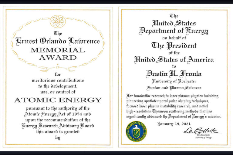 Photograph of an official award certificate from the US Department of Energy featuring ornate text and seals.