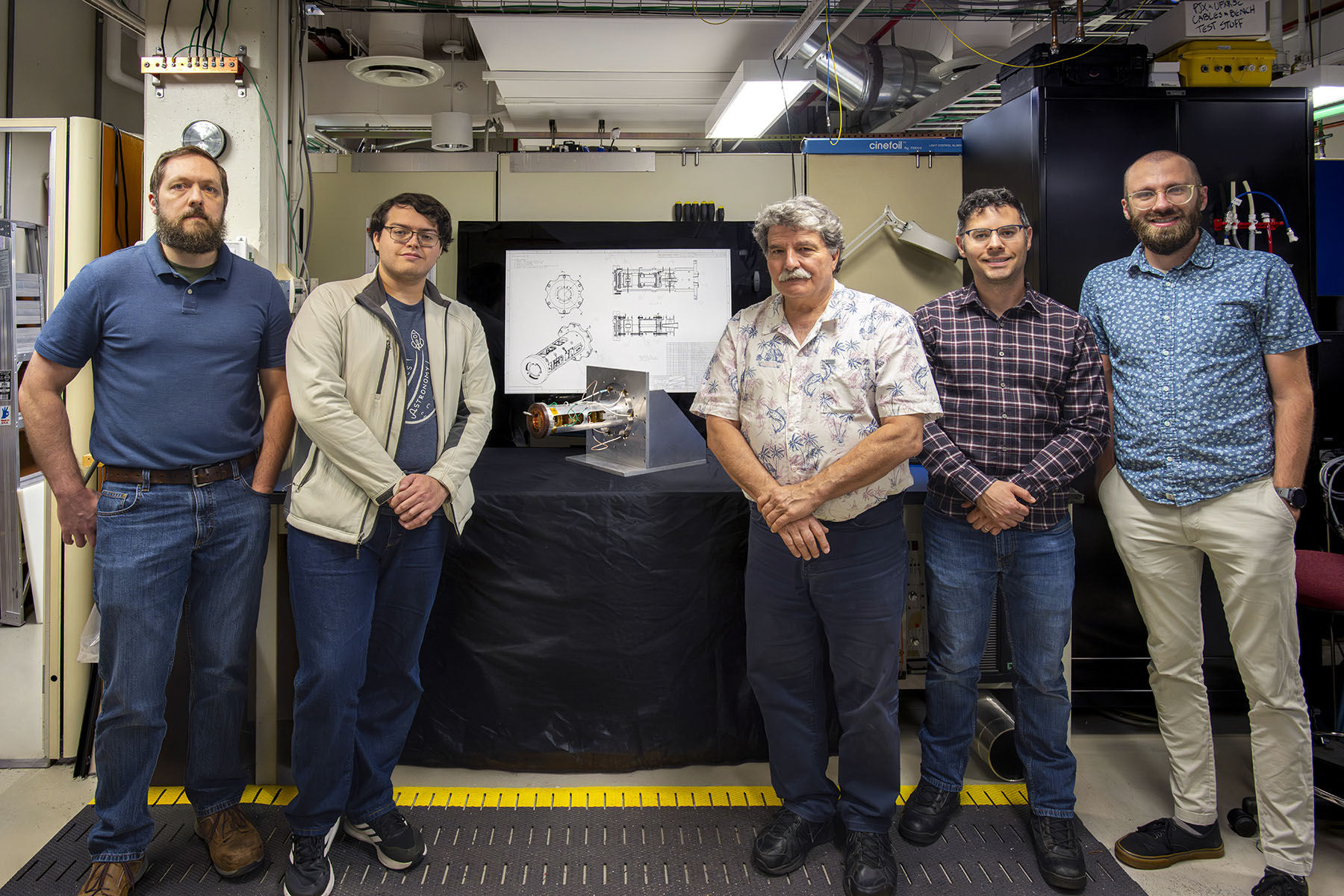 Group of people standing around BHx diagnostic in the Diagnostics Evaluation Lab.
