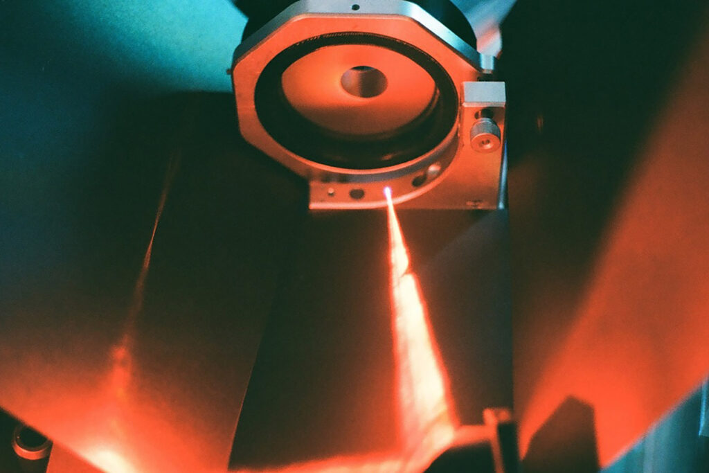 Close up photograph of equipment with a glowing red light.