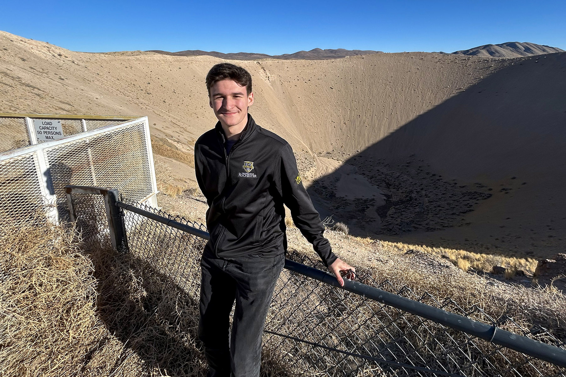 Marcos Ibáñez Matles standing in front of the NNSS Sedan Crater.