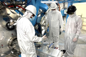 Visitors in cleanroom suits at the OMEGA target chamber.